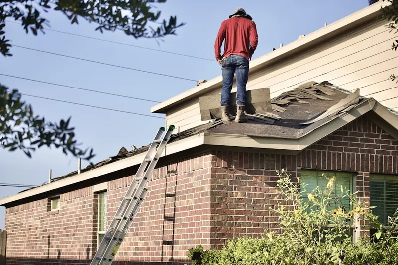Professional roofer working on a residential roof in East Weymouth